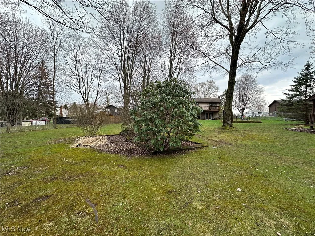 View of yard featuring fence