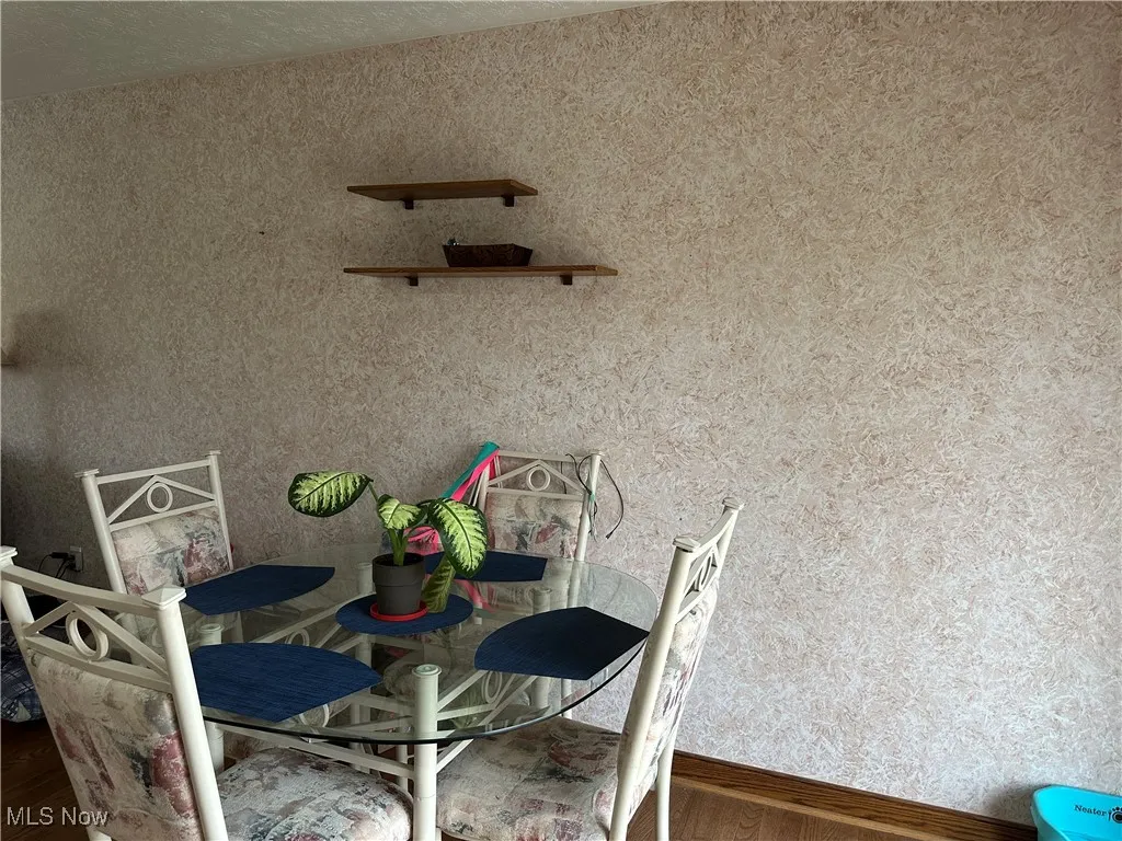 Unfurnished dining area featuring wood finished floors