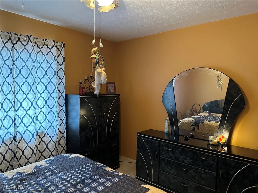 Carpeted bedroom featuring a textured ceiling
