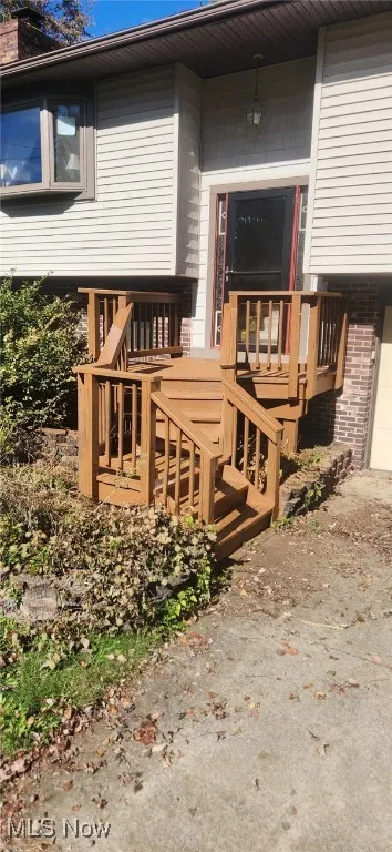 Property entrance with a deck and a garage