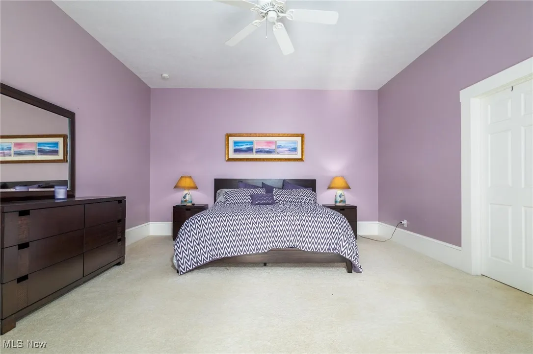 Bedroom with light carpet and ceiling fan