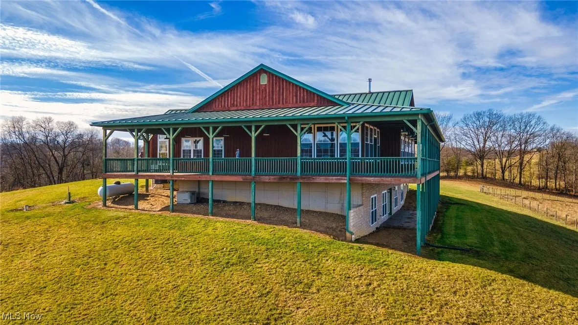 Back of house with a lawn