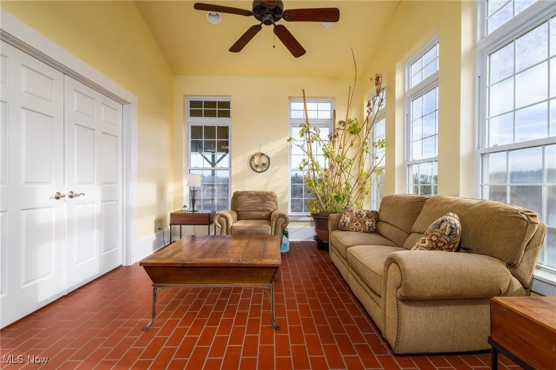 Sunroom featuring ceiling fan