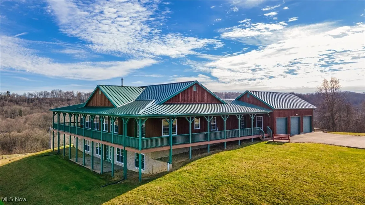 View of front of property featuring a garage and a front lawn