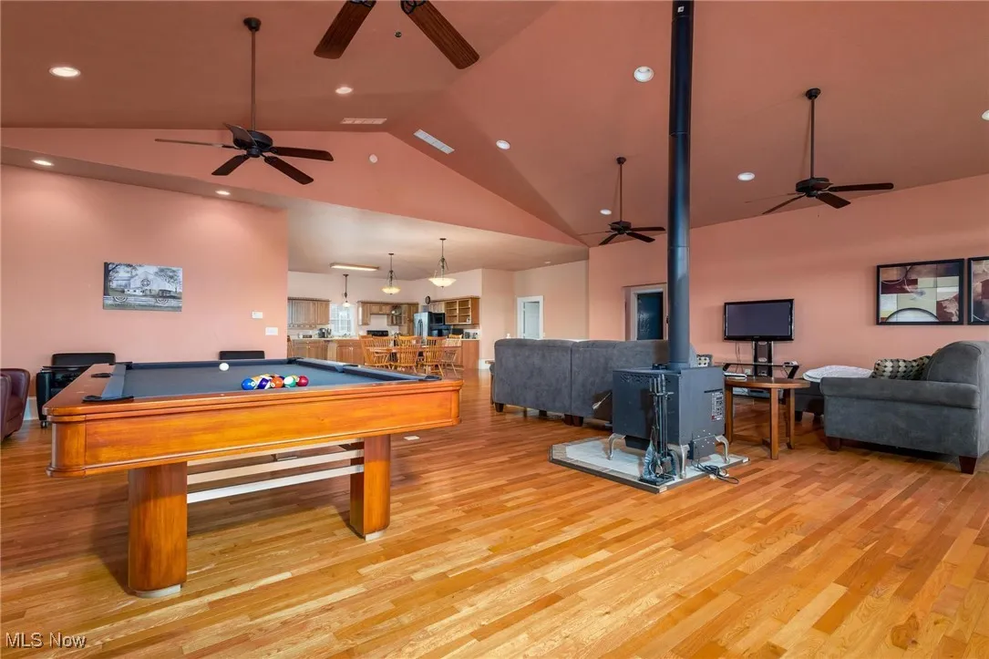 Playroom with pool table, ceiling fan, and light hardwood / wood-style floors