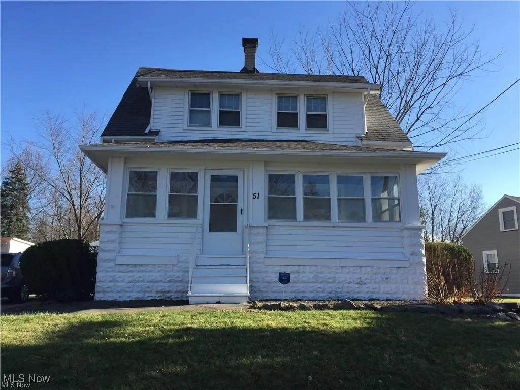 Bungalow with a shingled roof, a front yard, and entry steps