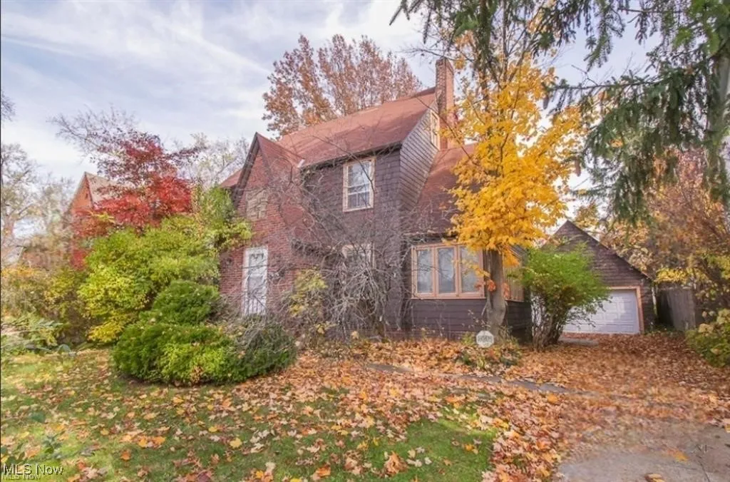 View of front of house with a garage and a chimney
