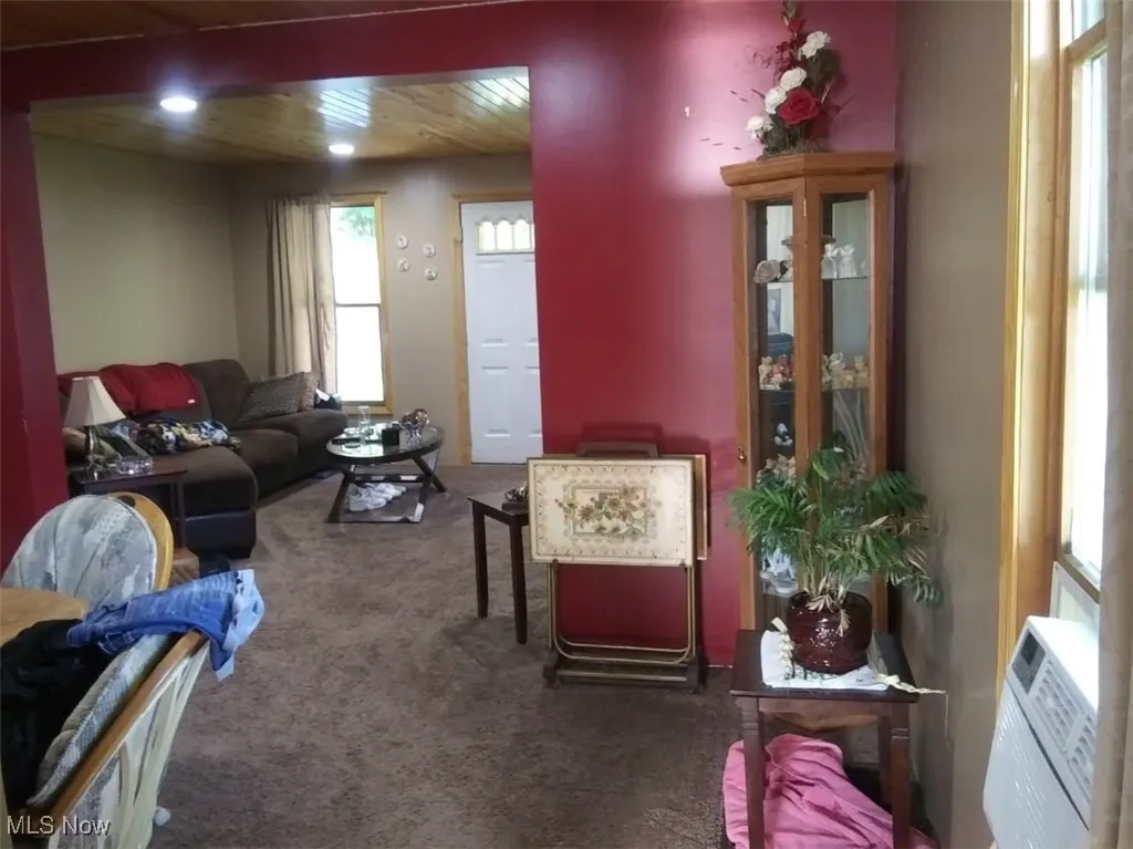Living area and dining room with carpet floors