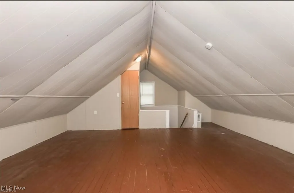 Bonus room featuring hardwood / wood-style floors and lofted ceiling