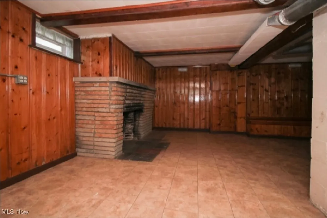 Basement with wood walls and a fireplace