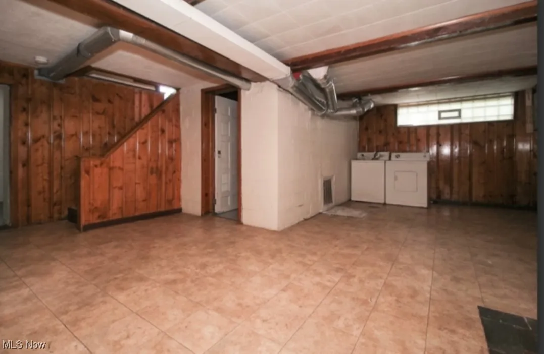 Below grade area featuring stairs and wood walls