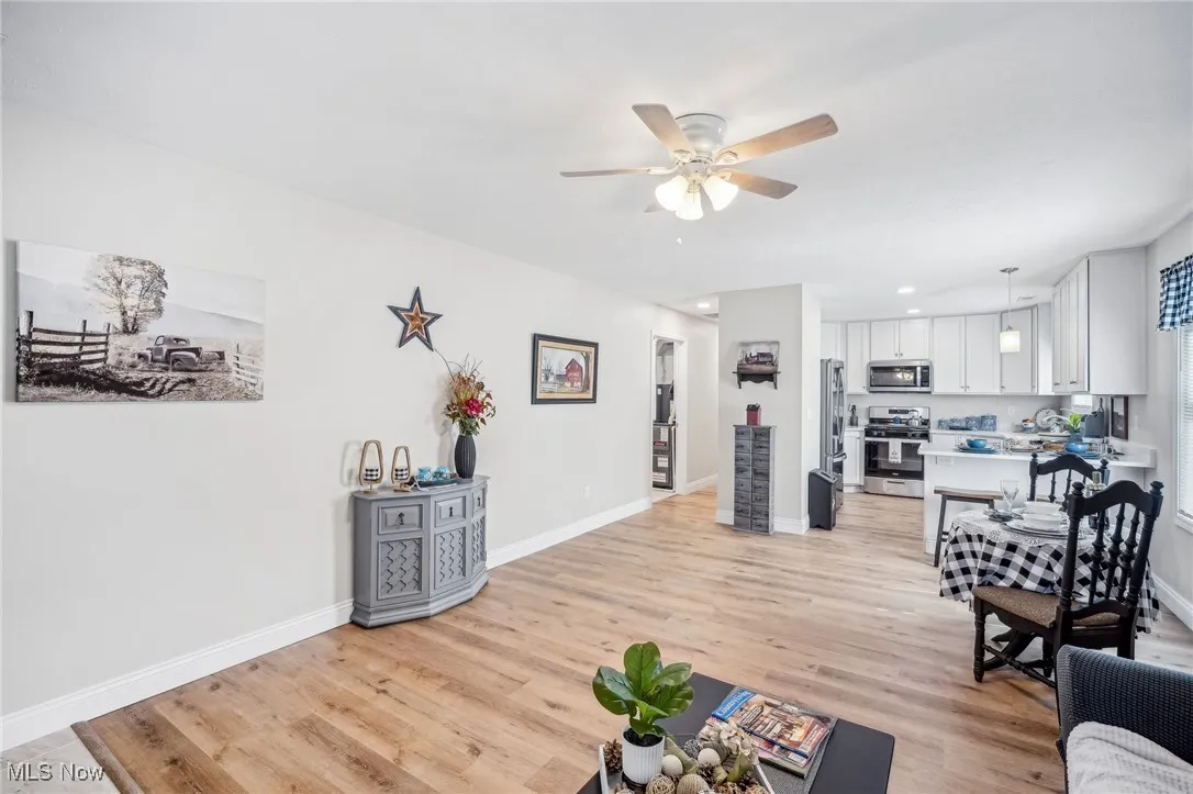 Living area with recessed lighting, baseboards, light wood-type flooring, and ceiling fan