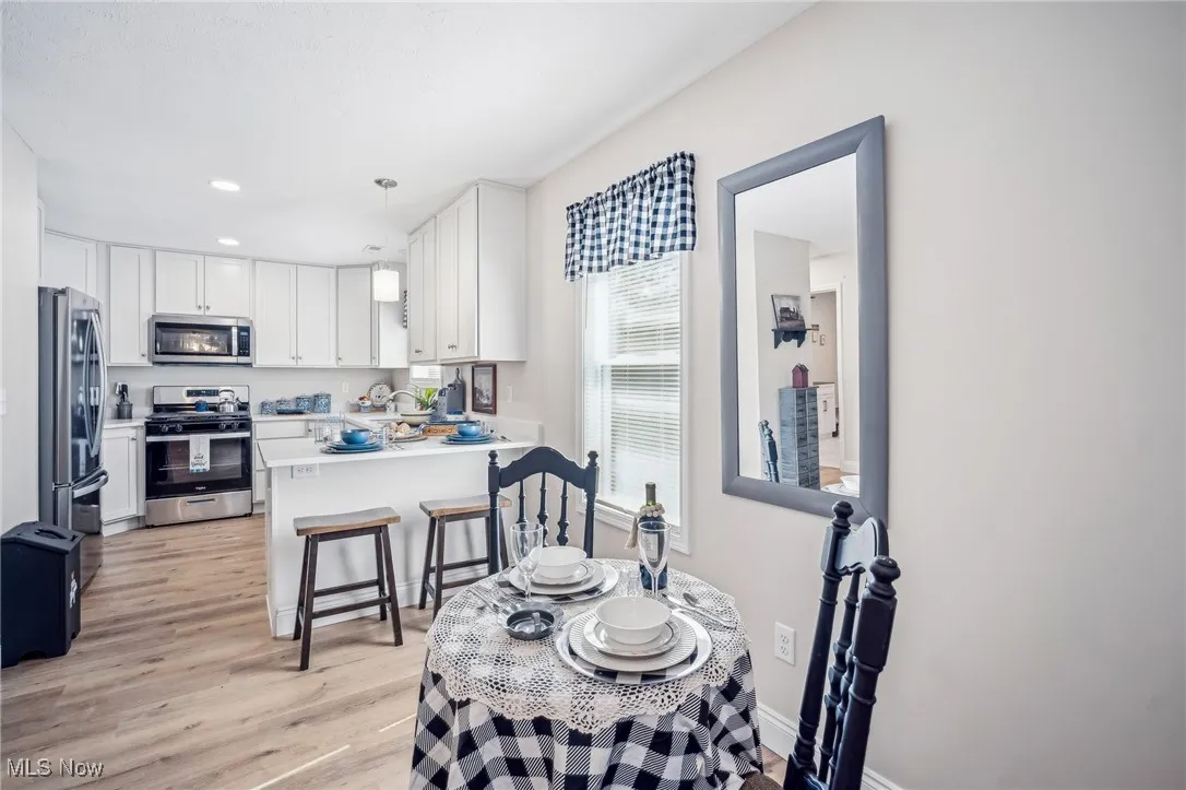 Dining space with recessed lighting, baseboards, and light wood-style flooring