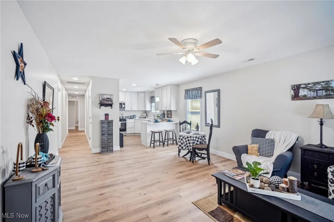 Living room with visible vents, light wood-style flooring, recessed lighting, baseboards, and ceiling fan