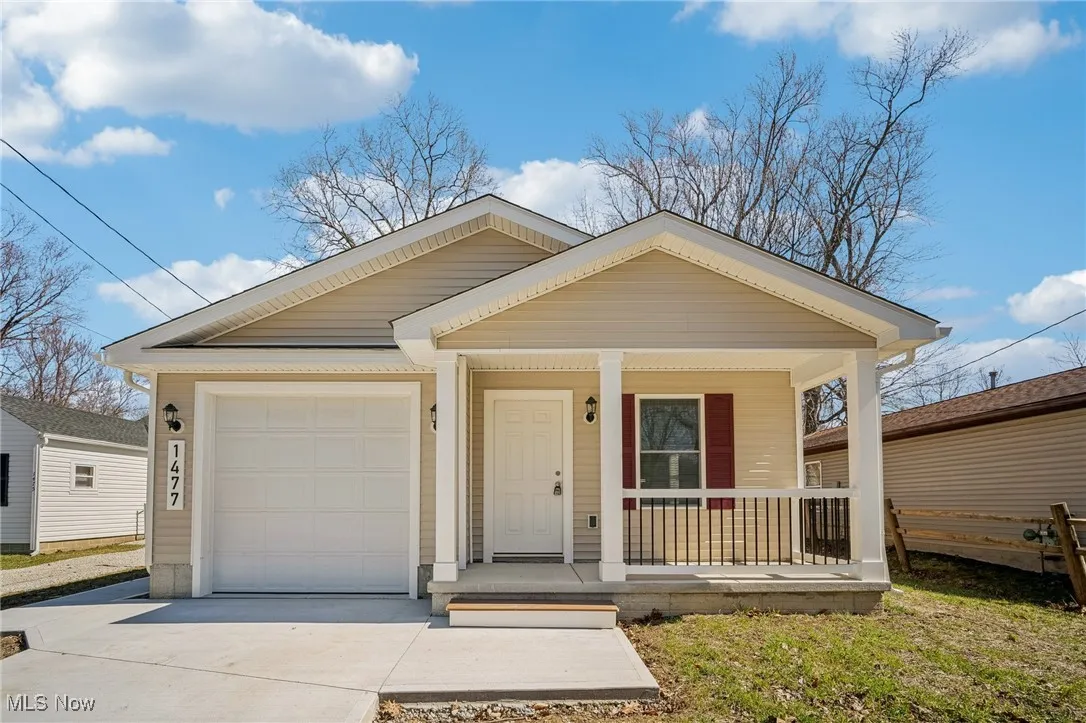 View of front of house with a porch, concrete driveway, and an attached garage