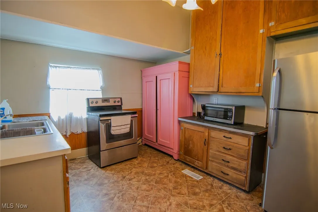 Kitchen featuring visible vents, a sink, and appliances with stainless steel finishes