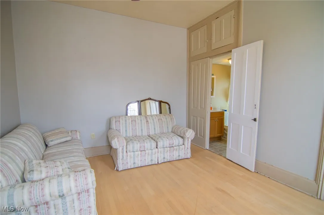 Sitting room with wood finished floors and baseboards