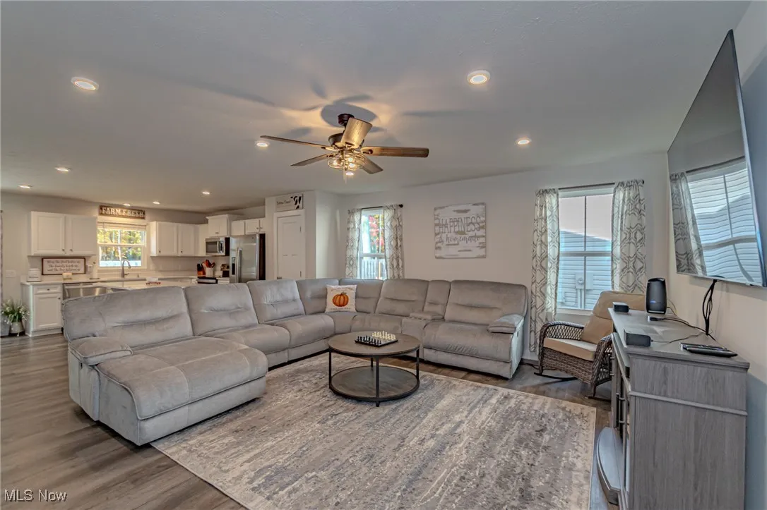 Living area featuring recessed lighting, a ceiling fan, and wood finished floors