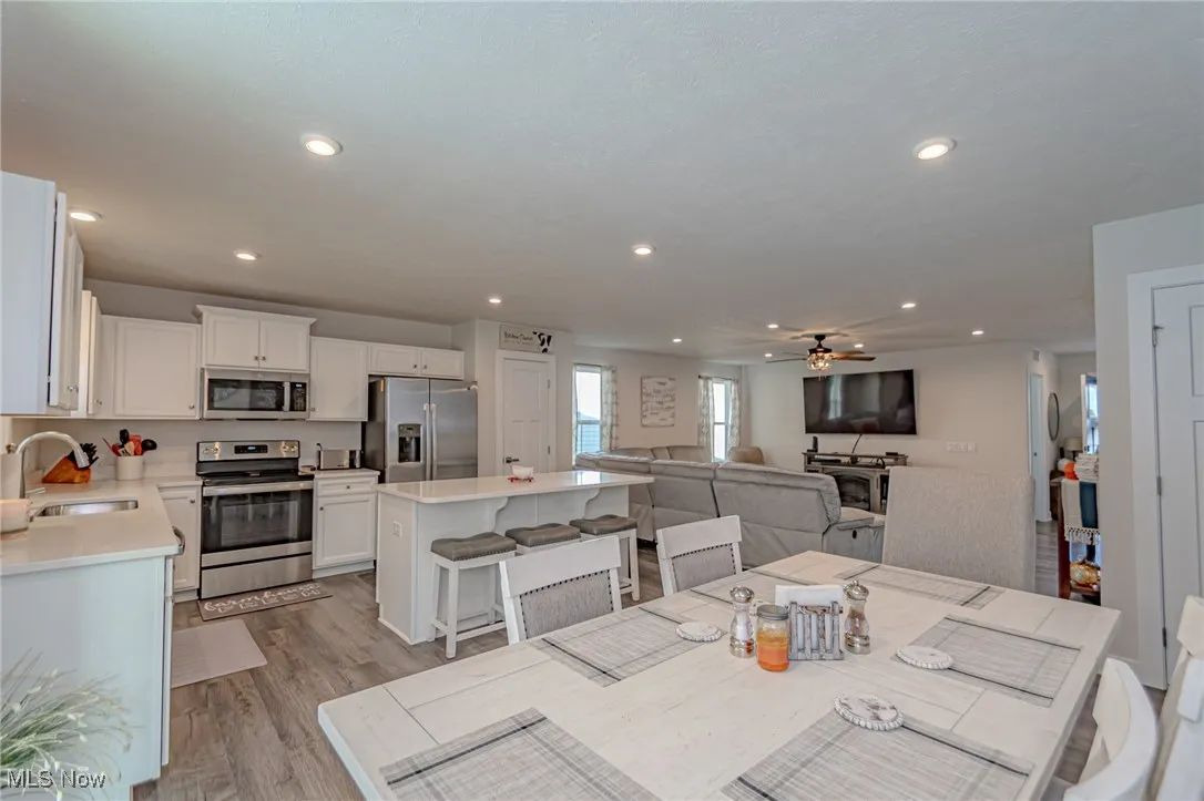 Dining area with recessed lighting, light wood-style flooring, and ceiling fan