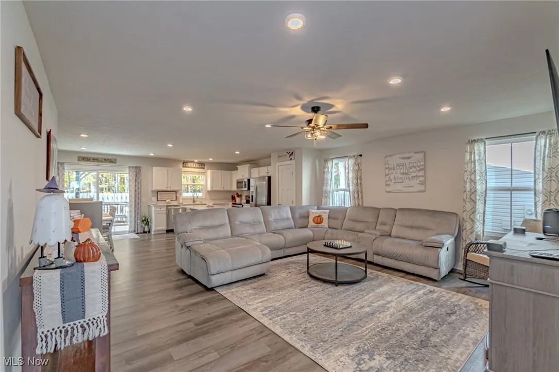 Living area featuring recessed lighting, light wood-type flooring, and a ceiling fan