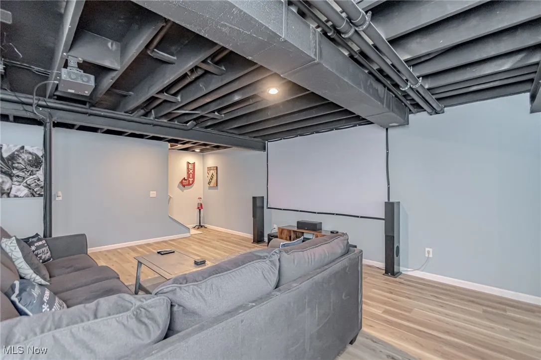 Cinema featuring wood finished floors and baseboards