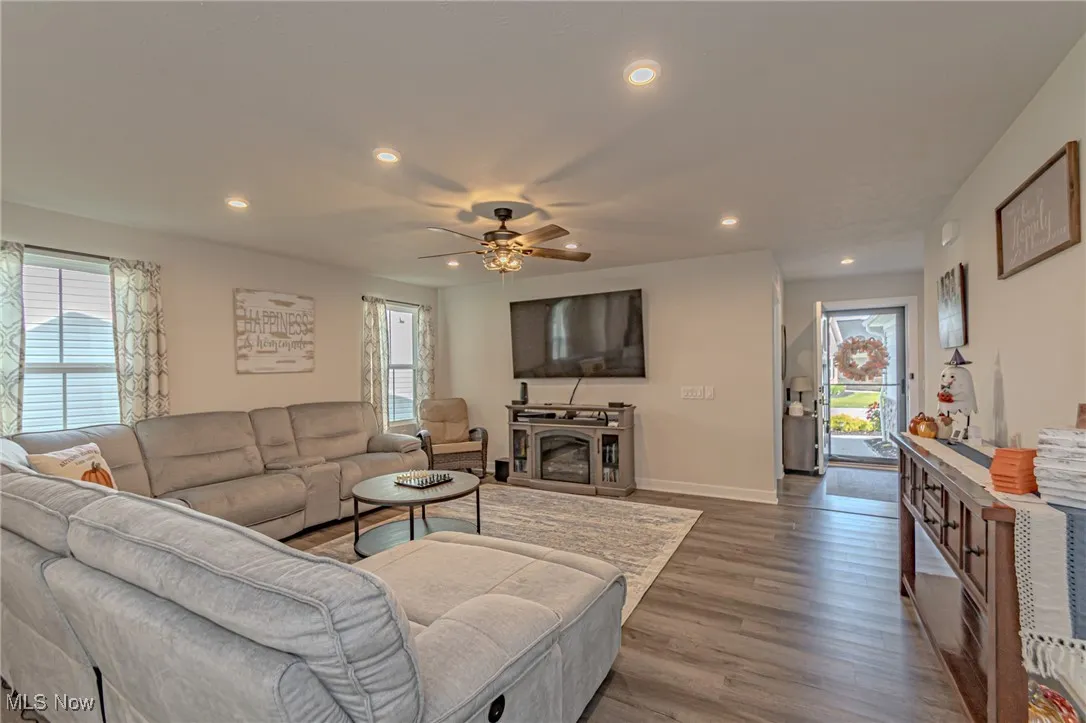 Living room featuring ceiling fan, recessed lighting, wood finished floors, and baseboards