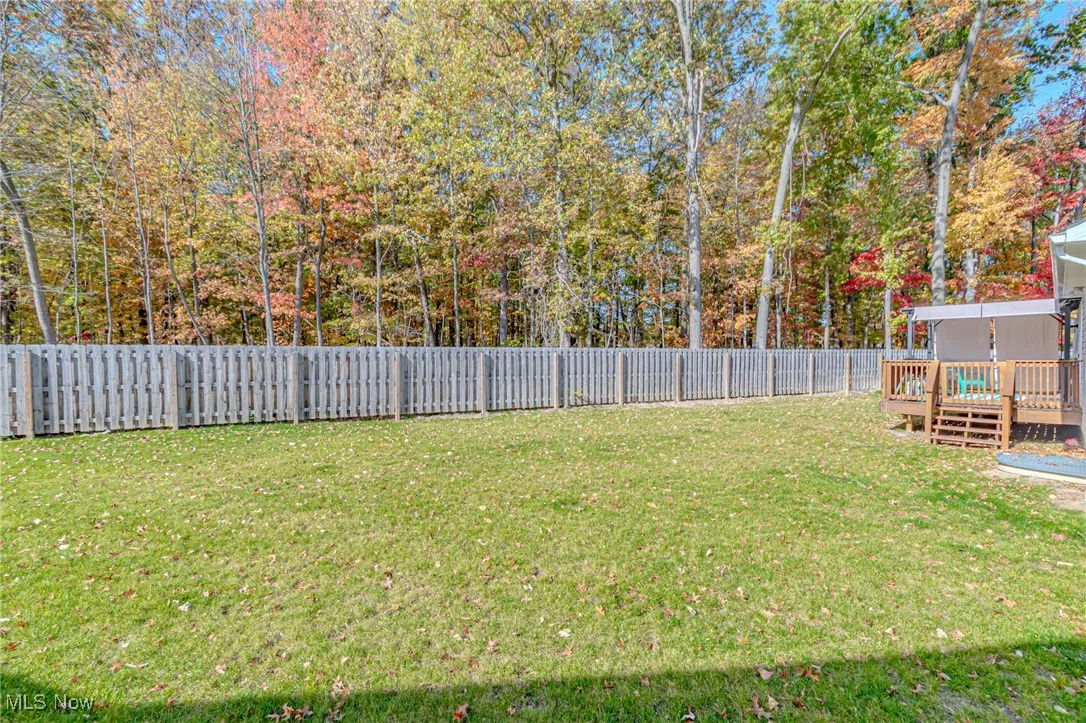 View of yard featuring a fenced backyard and a wooden deck