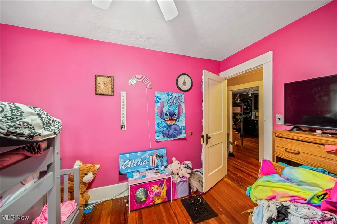 Bedroom with ceiling fan and wood finished floors