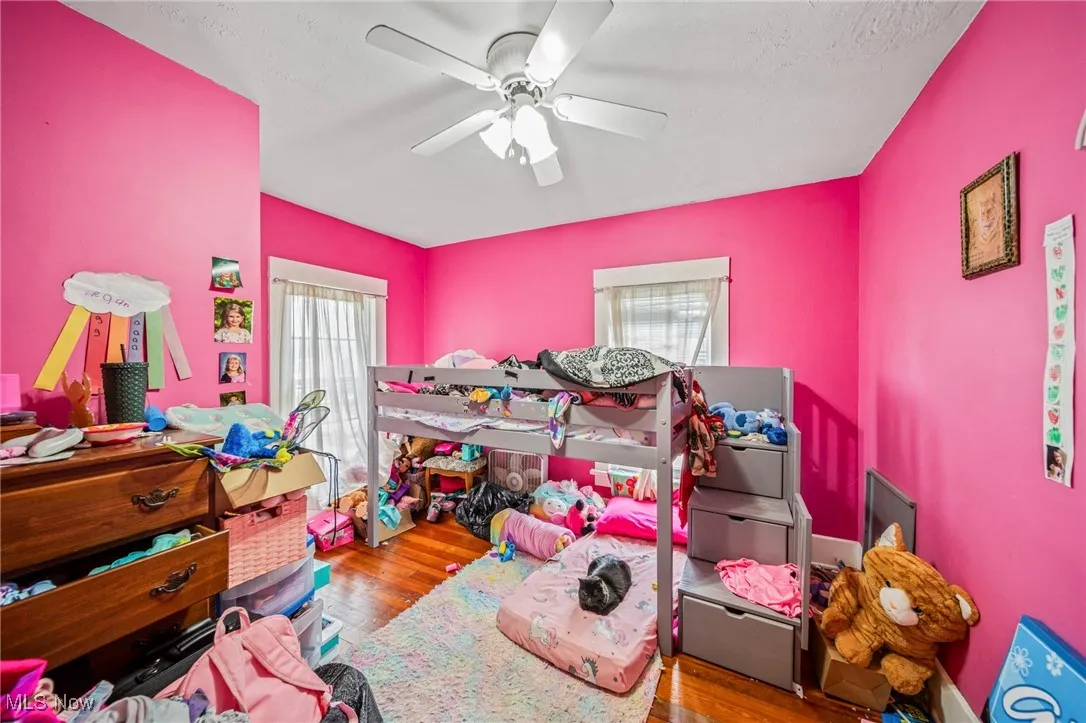 Bedroom with ceiling fan and wood finished floors