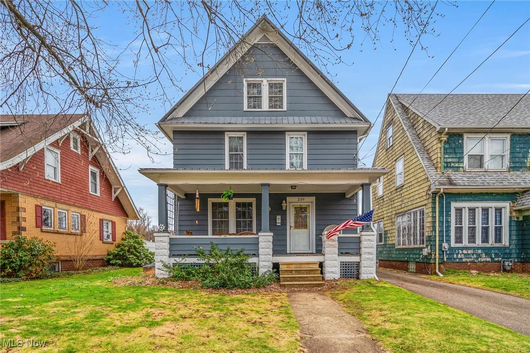 Traditional style home with a front yard and a porch