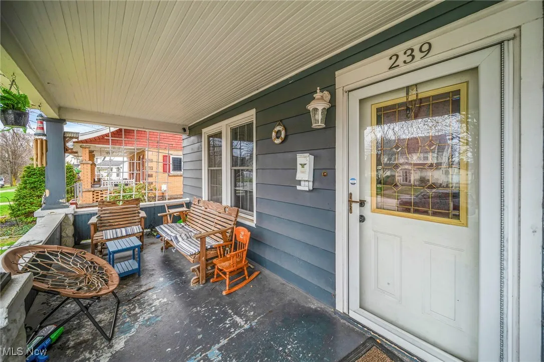 Doorway to property featuring covered porch