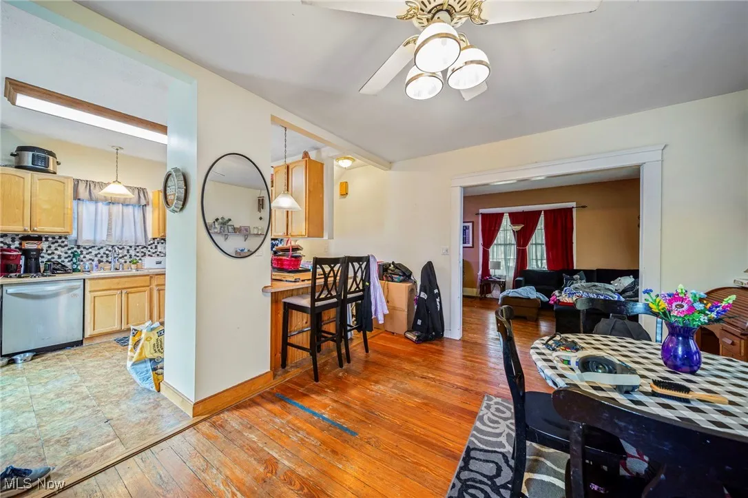 Dining area featuring light wood-style flooring, ceiling fan, and baseboards