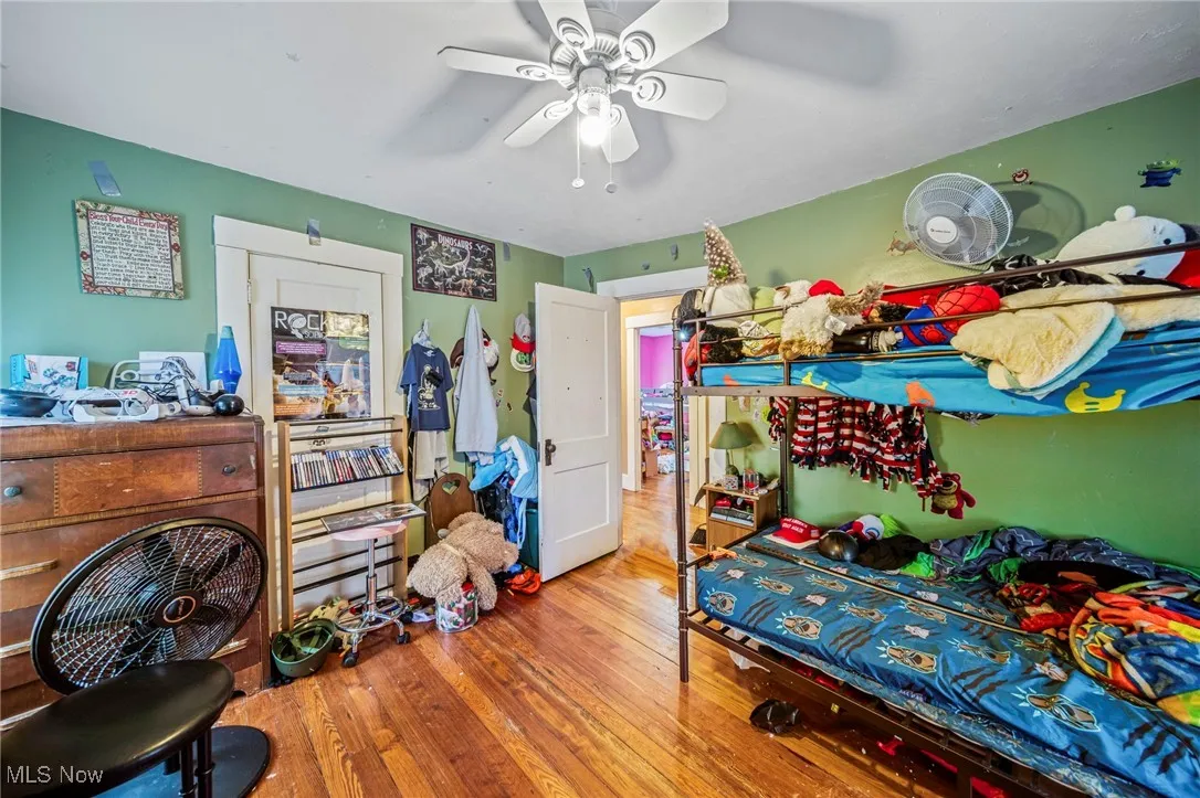 Bedroom featuring ceiling fan and wood finished floors