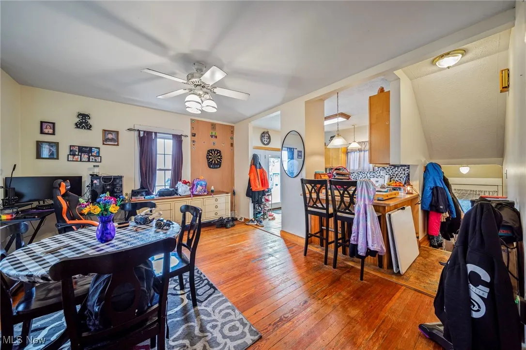 Dining space with hardwood / wood-style floors and a ceiling fan