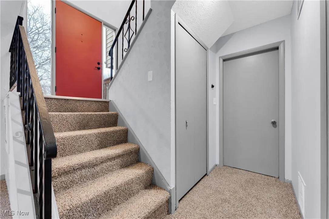 Stairway with carpet and visible vents