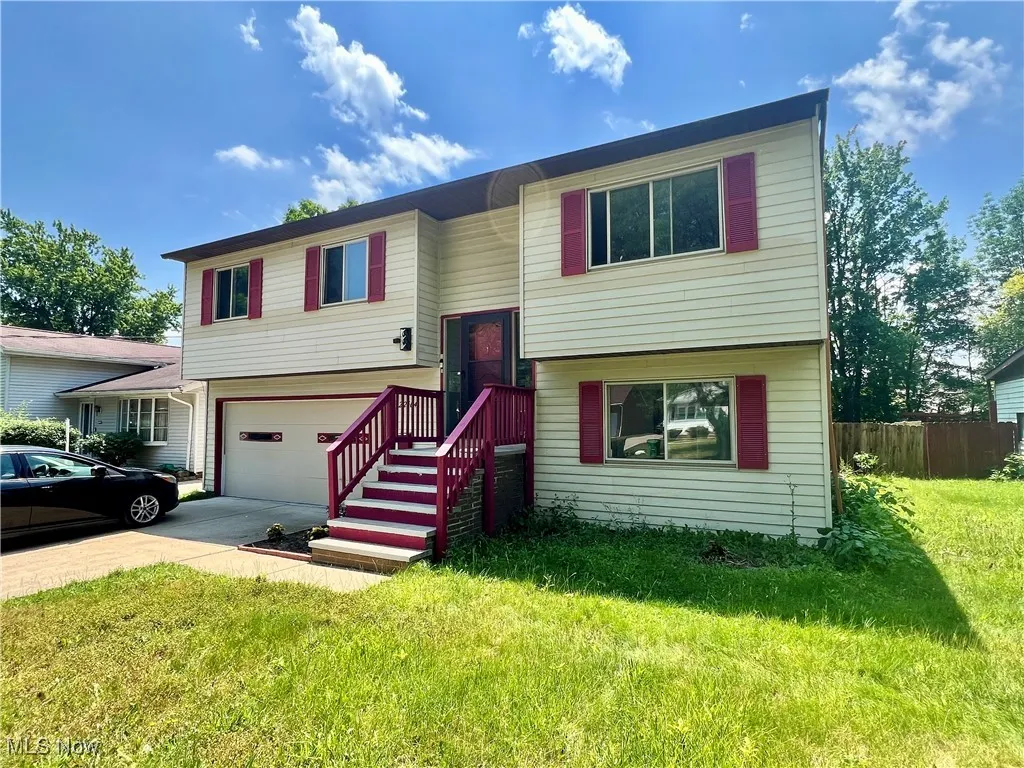 Bi-level home with concrete driveway and a garage