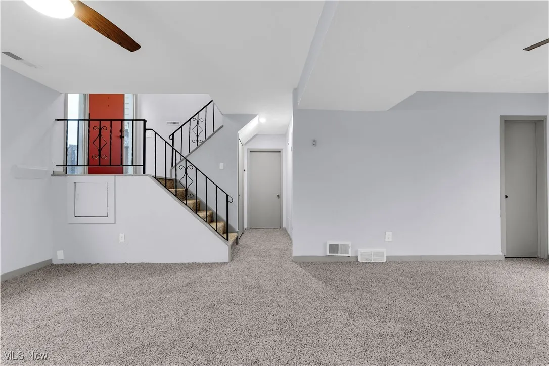 Unfurnished living room with visible vents and carpet floors