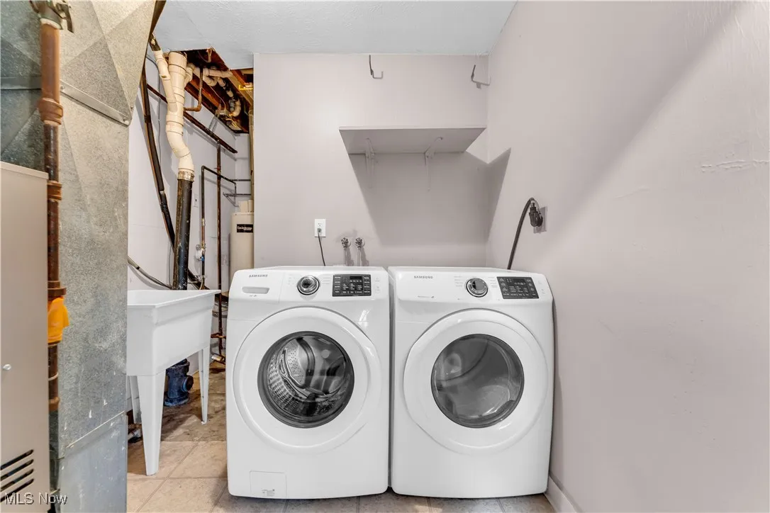 Washroom featuring washer and dryer and laundry area
