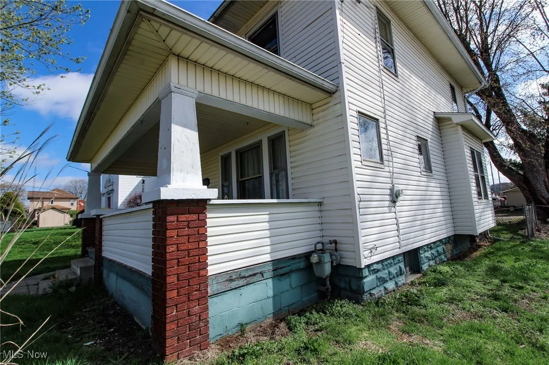 View of property exterior with covered porch