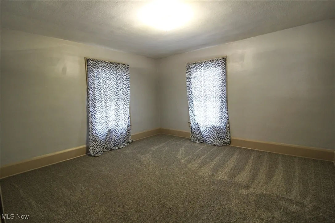 Spare room with carpet flooring and baseboards