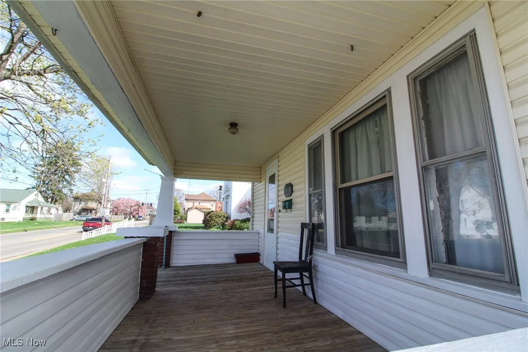Wooden terrace featuring covered porch and a residential view