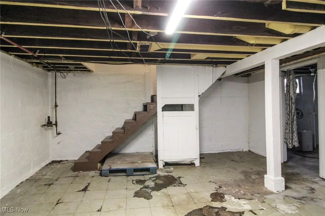 Unfinished basement featuring stairway