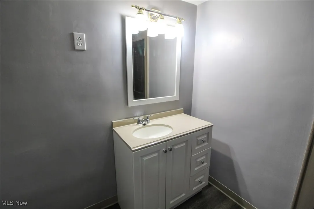 Bathroom featuring baseboards and vanity
