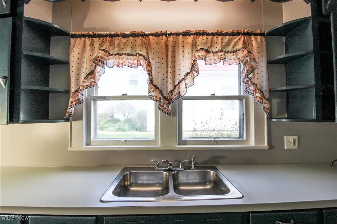 Kitchen with a sink and open shelves