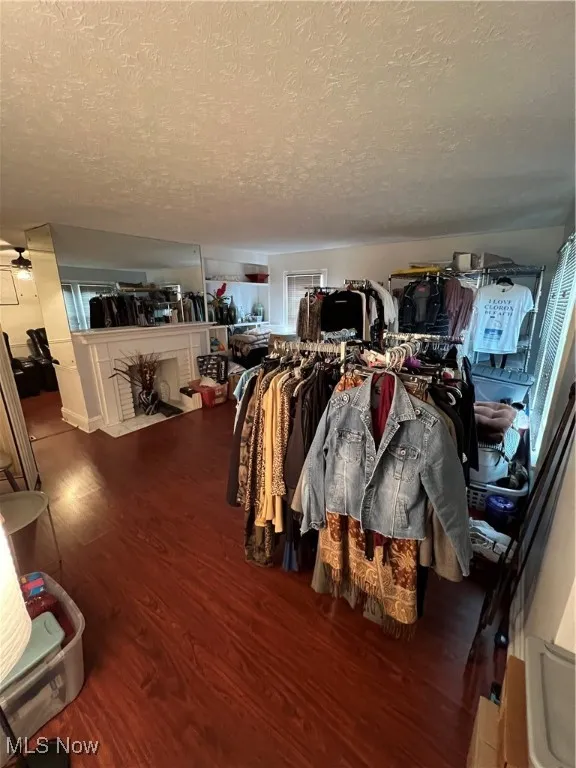 Misc room with a textured ceiling and wood finished floors