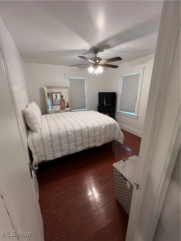 Bedroom featuring ceiling fan and dark wood-style floors