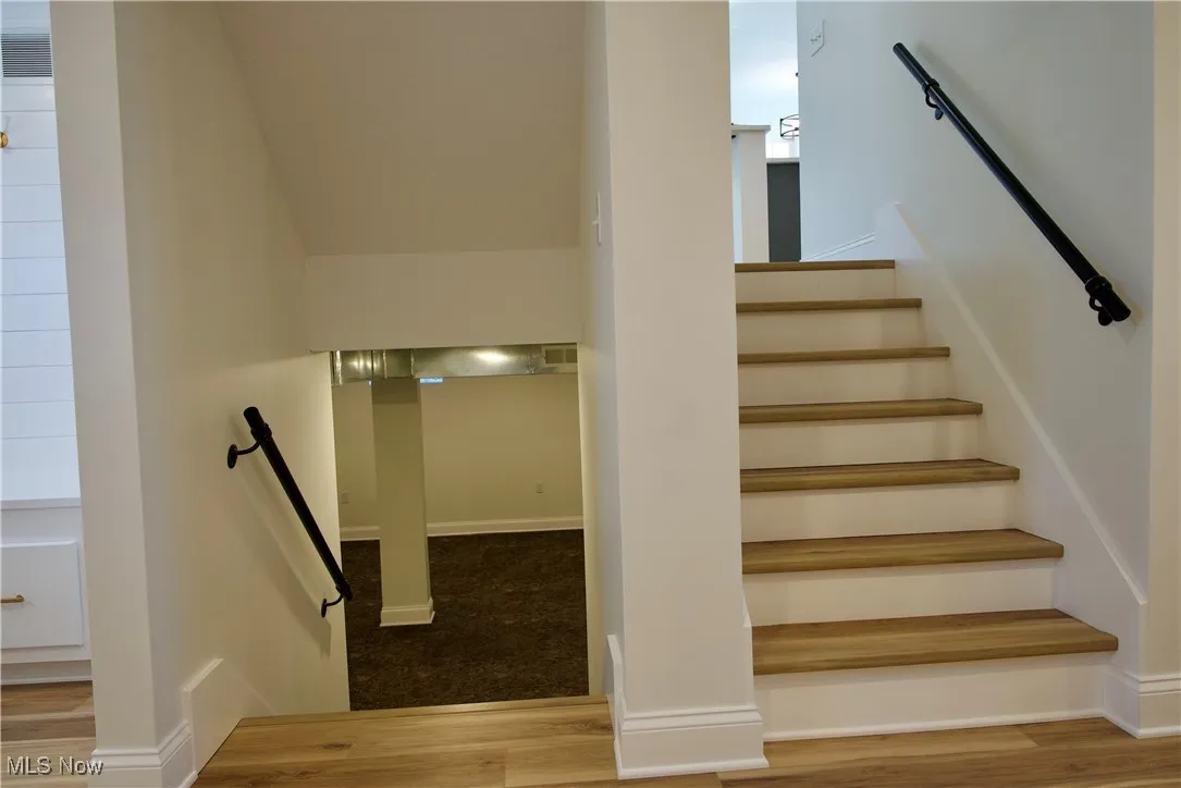 Stairway looking down into the basement area and up into the living room/kitchen