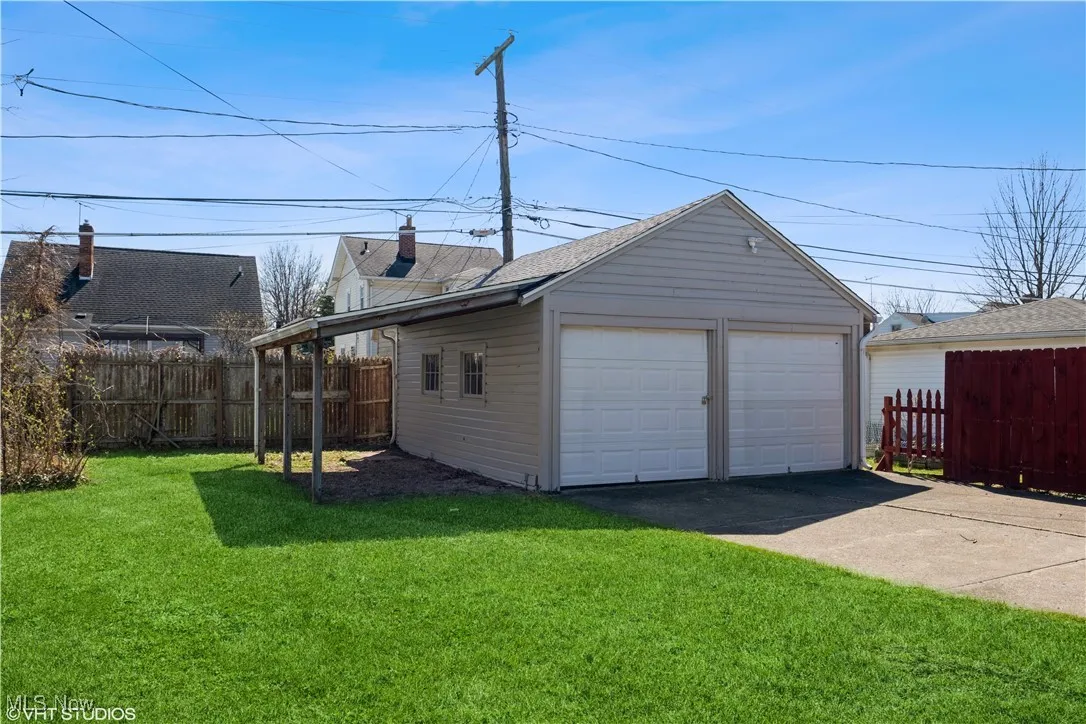 Detached garage featuring fence