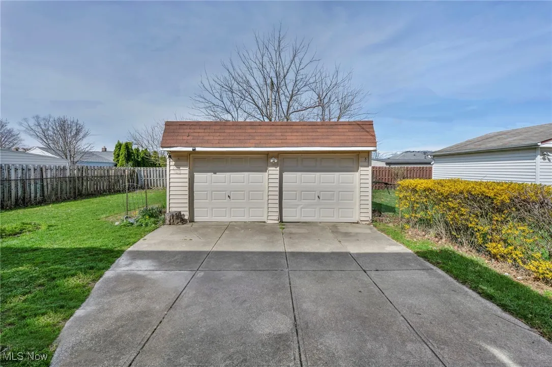 Detached garage featuring fence