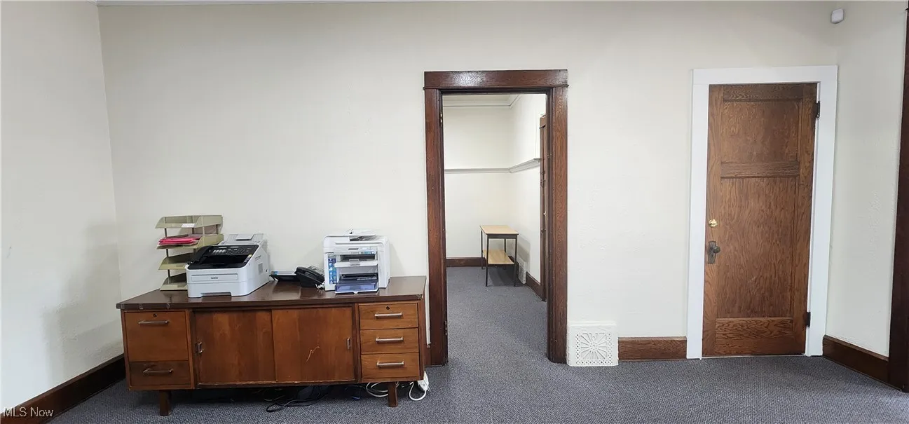 Home office with dark carpet